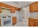 Bright kitchen featuring white appliances, light wood cabinets, and tile flooring at 6432 Jean Lee Dr, Las Vegas, NV 89108