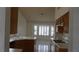 Traditional kitchen boasts wood cabinetry, white countertops, and sun-filled breakfast nook at 6432 Jean Lee Dr, Las Vegas, NV 89108