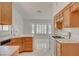 Bright kitchen featuring white appliances and tile flooring at 6432 Jean Lee Dr, Las Vegas, NV 89108