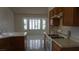 Traditional kitchen boasts wood cabinetry, white countertops, and sun-filled breakfast nook at 6432 Jean Lee Dr, Las Vegas, NV 89108