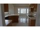 Traditional kitchen boasts wood cabinetry, white countertops, and sun-filled breakfast nook at 6432 Jean Lee Dr, Las Vegas, NV 89108