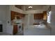 Traditional kitchen showcasing ample cabinetry, and bright countertops, with a view of the fireplace at 6432 Jean Lee Dr, Las Vegas, NV 89108