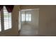 Living room with tile floors, shuttered windows, and an entry door at 6432 Jean Lee Dr, Las Vegas, NV 89108