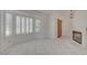 Bright living room featuring tile floors, shutters, and a fireplace at 6432 Jean Lee Dr, Las Vegas, NV 89108