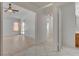 Open concept living room with ceiling fan, tile floor and sliding glass door for natural light at 6432 Jean Lee Dr, Las Vegas, NV 89108