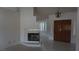 View of the living room with a tile fireplace, tile floors, shuttered windows, and a light fixture at 6432 Jean Lee Dr, Las Vegas, NV 89108