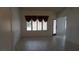 Open living room with tile floors, shuttered windows, and an entry door at 6432 Jean Lee Dr, Las Vegas, NV 89108