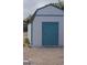 Backyard shed with white siding and turquoise trim on a gravel and dirt lot at 6432 Jean Lee Dr, Las Vegas, NV 89108