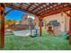 Backyard with playhouse, basketball court, turf, patio, and pergola at 644 Mauna Kea Pl, Henderson, NV 89011