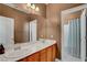 Bathroom with double sinks, wood cabinets, a large mirror, and a separate shower at 644 Mauna Kea Pl, Henderson, NV 89011