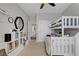 Bright bedroom with a ceiling fan, a large window, a bunk bed, and a closet for convenience and functionality at 644 Mauna Kea Pl, Henderson, NV 89011