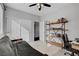 Bright bedroom with a futon, open bookshelf, and a ceiling fan with light at 644 Mauna Kea Pl, Henderson, NV 89011