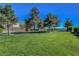 The community park features mature trees, lush green grass, and walking paths for outdoor enjoyment at 644 Mauna Kea Pl, Henderson, NV 89011