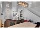 Elegant dining room featuring high ceilings, modern decor, and hardwood floors, with stairs leading upstairs at 644 Mauna Kea Pl, Henderson, NV 89011