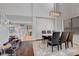Bright dining room featuring hardwood floors, a modern table with seating for six, and stairs leading up at 644 Mauna Kea Pl, Henderson, NV 89011