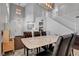 Open dining area boasts high ceilings, modern lighting, hardwood floors, and a staircase to the upper level at 644 Mauna Kea Pl, Henderson, NV 89011