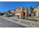 Charming two-story home with a tile roof, complemented by a well-manicured front yard and an attached two-car garage at 644 Mauna Kea Pl, Henderson, NV 89011