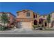 Charming two-story home with a tile roof, complemented by a well-manicured front yard and an attached two-car garage at 644 Mauna Kea Pl, Henderson, NV 89011