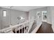 Upstairs hallway features hardwood floors and leads to other areas, ensuring seamless transitions throughout the home at 644 Mauna Kea Pl, Henderson, NV 89011