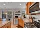 Cozy kitchen with granite counters, stainless steel appliances, wooden cabinets, tile floor, and casual dining area at 644 Mauna Kea Pl, Henderson, NV 89011