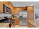 Well-equipped kitchen features stainless steel appliances, plenty of wood cabinets, and granite countertops at 644 Mauna Kea Pl, Henderson, NV 89011