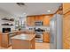 Bright kitchen showcases granite countertops, wood cabinetry, stainless steel appliances, and tile flooring at 644 Mauna Kea Pl, Henderson, NV 89011