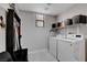 Functional laundry area featuring modern washer and dryer units with some open storage at 644 Mauna Kea Pl, Henderson, NV 89011