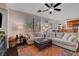 Bright living room featuring a ceiling fan, modern furniture, and a colorful rug at 644 Mauna Kea Pl, Henderson, NV 89011