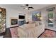 Inviting living room with fireplace, television, comfortable seating, and a door to the outdoor space at 644 Mauna Kea Pl, Henderson, NV 89011