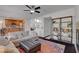 Bright living room featuring a ceiling fan, modern furniture, and a colorful rug at 644 Mauna Kea Pl, Henderson, NV 89011