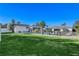 Spacious backyard with a well-maintained lawn, pool, lounge chairs, and outdoor seating areas under umbrellas at 6965 Tara Ave, Las Vegas, NV 89117