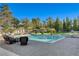 Beautiful backyard with a pool, comfortable lounge seating, and a ping pong table and volleyball court beyond the pool at 6965 Tara Ave, Las Vegas, NV 89117