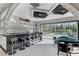 Stylish bar area with counter seating and easy access to outdoor pool and lounge area for entertainment at 6965 Tara Ave, Las Vegas, NV 89117