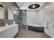 This bathroom features a glass enclosed shower, a luxurious soaking tub, and modern double vanity at 6965 Tara Ave, Las Vegas, NV 89117