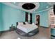 This bedroom features a unique round bed, stylish black out curtains, and vibrant teal walls at 6965 Tara Ave, Las Vegas, NV 89117