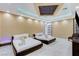This modern bedroom features two beds, sleek design, and a well-lit coffered ceiling at 6965 Tara Ave, Las Vegas, NV 89117