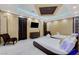 This luxurious bedroom offers two beds, soft carpeting, and a beautifully lit coffered ceiling at 6965 Tara Ave, Las Vegas, NV 89117