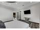 Modern bedroom with mounted TV, unique decor, and gray-toned marble floors at 6965 Tara Ave, Las Vegas, NV 89117