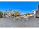 A large paved driveway provides ample parking, complemented by lush landscaping and privacy gates at 6965 Tara Ave, Las Vegas, NV 89117