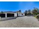 Striking single-story home featuring a modern design, grand driveway, and a sleek black garage door at 6965 Tara Ave, Las Vegas, NV 89117
