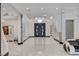 Grand foyer featuring unique architectural elements, elegant marble floors, and stylish lighting fixtures at 6965 Tara Ave, Las Vegas, NV 89117