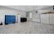 Spacious garage with tiled floors, storage cabinets, and modern appliances at 6965 Tara Ave, Las Vegas, NV 89117