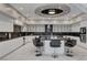 Chef's kitchen features an oversized center island and luxe marble backsplash at 6965 Tara Ave, Las Vegas, NV 89117