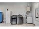 Well-equipped laundry room with modern washer and dryer, a utility sink, and storage cabinet at 6965 Tara Ave, Las Vegas, NV 89117