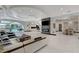 A spacious living room with marble floors seamlessly connects to an outdoor pool and dining area at 6965 Tara Ave, Las Vegas, NV 89117