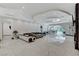 Bright living room featuring recessed ceiling lights, marble flooring and a modern couch at 6965 Tara Ave, Las Vegas, NV 89117