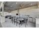 Outdoor kitchen and dining with fireplace and stainless steel appliances at 6965 Tara Ave, Las Vegas, NV 89117