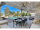 Stunning outdoor kitchen and dining area overlooking the pool, perfect for entertaining guests at 6965 Tara Ave, Las Vegas, NV 89117