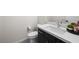 Modern half bath with a dark vanity, stylish fixtures, and minimalist decor at 717 Monroe Hill Pl, Henderson, NV 89011