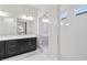 Bathroom showcasing a double sink vanity with a modern glass shower and large mirror at 717 Monroe Hill Pl, Henderson, NV 89011